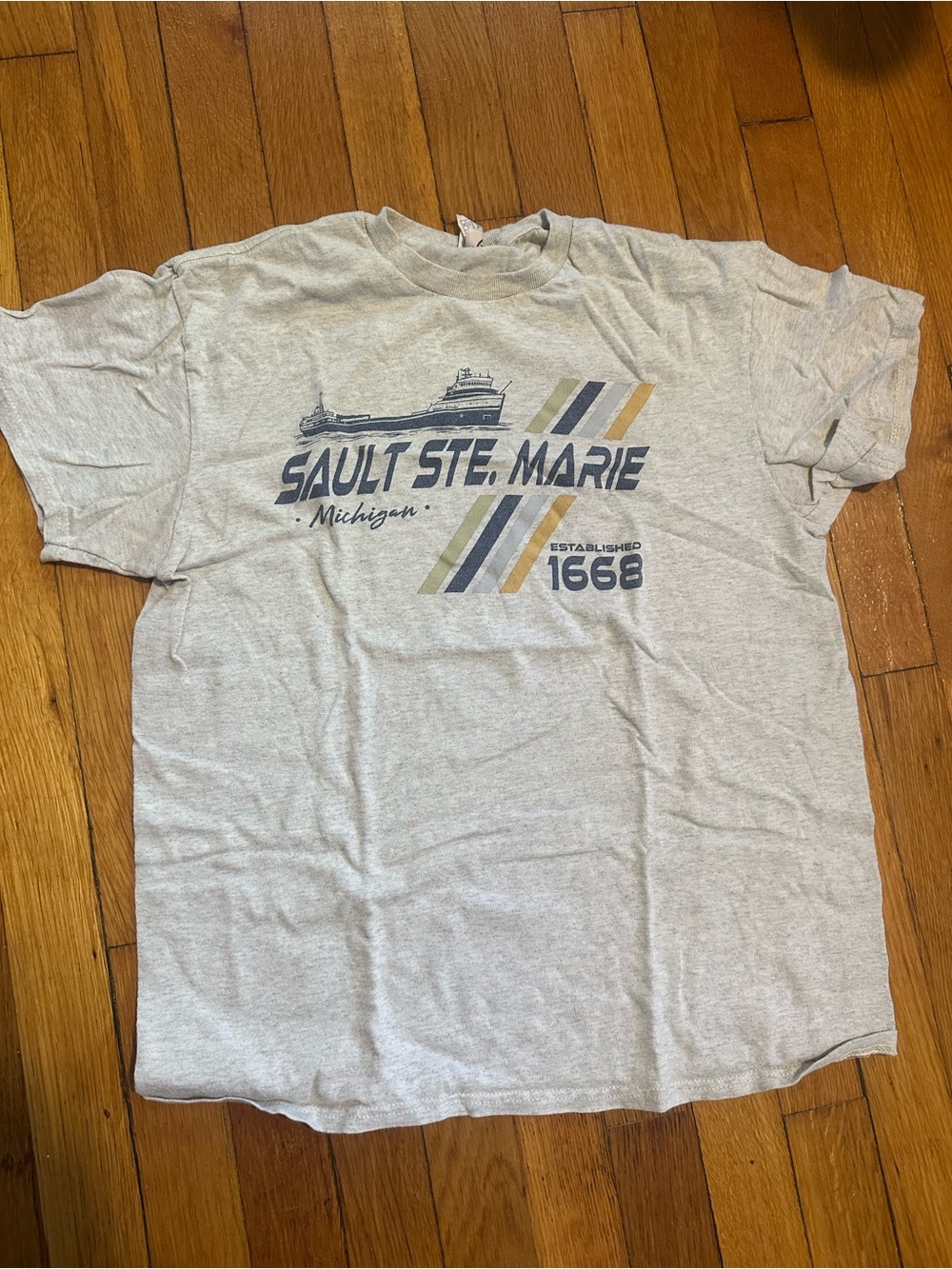 Delta Light Gray Sault Ste. Marie Graphic Tee with Navy and Gold Accents